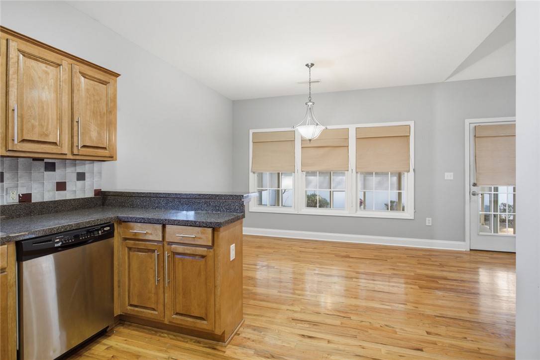 201 Providence Court Seneca, SC 29678 - Photo 13 of 33 This bright kitchen and dining area features warm wood flooring and ample natural light.