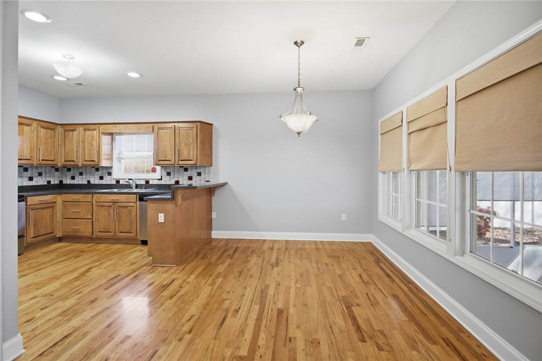 201 Providence Court Seneca, SC 29678 - Photo 14 of 33 This inviting kitchen and dining area features polished hardwood floors and ample natural light.