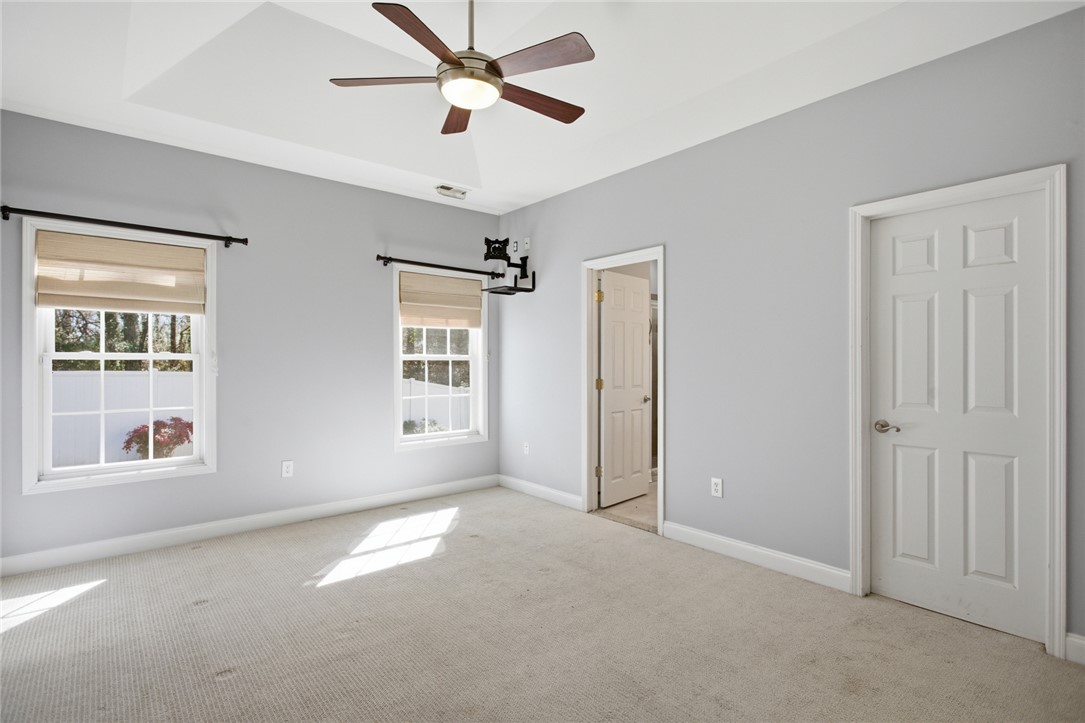 201 Providence Court Seneca, SC 29678 - Photo 15 of 33 This spacious room features ample natural light and a classic ceiling fan, offering comfort and style.