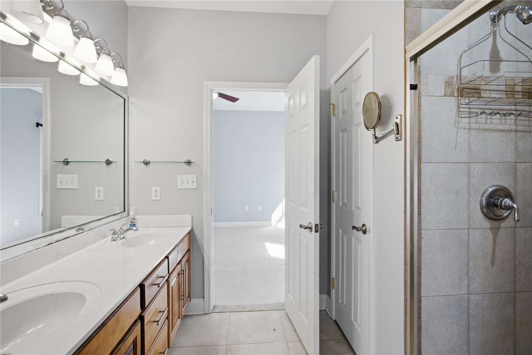 201 Providence Court Seneca, SC 29678 - Photo 20 of 33 This bathroom features a double vanity with ample counter space and a tiled shower.
