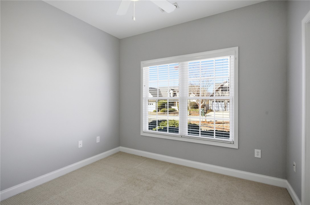 201 Providence Court Seneca, SC 29678 - Photo 21 of 33 This cozy bedroom features soft carpeting and a bright window overlooking the neighborhood.