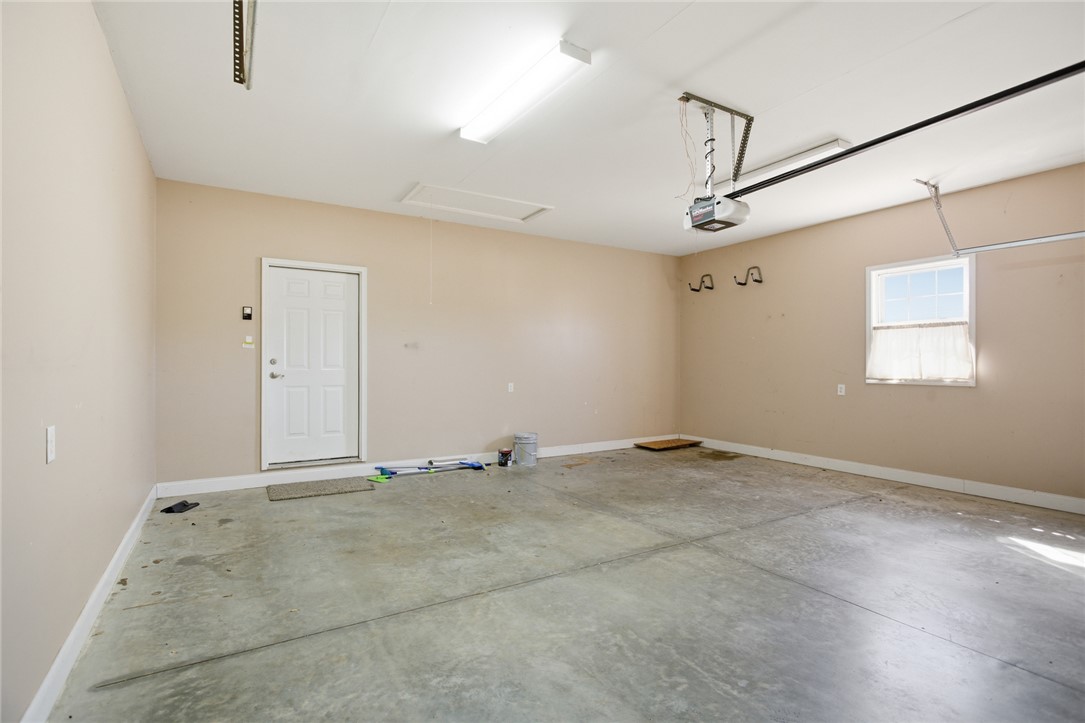 201 Providence Court Seneca, SC 29678 - Photo 28 of 33 This spacious garage offers ample room for vehicles and storage, with durable concrete flooring.