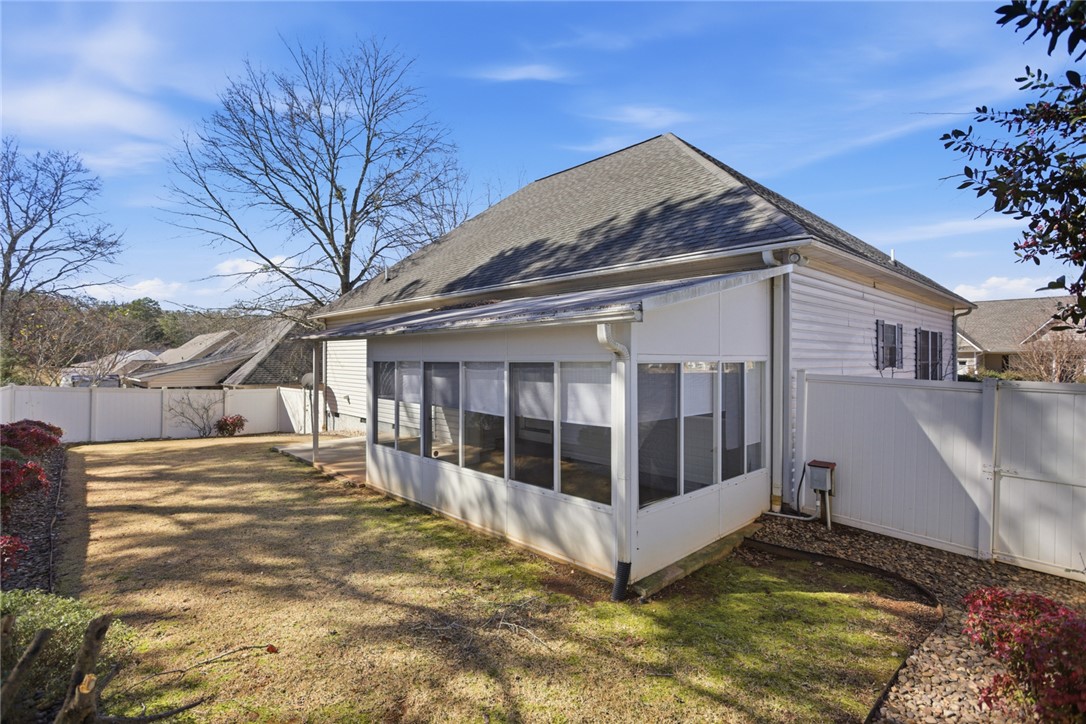 201 Providence Court Seneca, SC 29678 - Photo 6 of 33 This house features a delightful sunroom and a well-maintained yard, perfect for outdoor enjoyment.