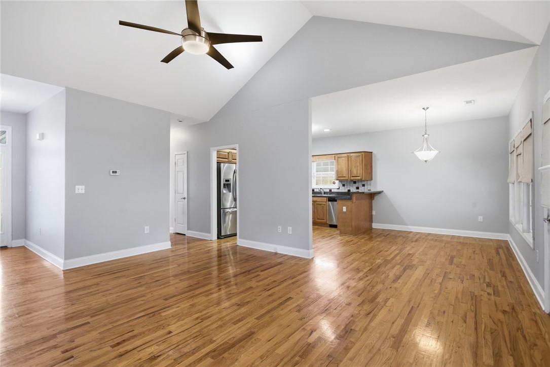 201 Providence Court Seneca, SC 29678 - Photo 8 of 33 This bright, airy interior features vaulted ceilings and gleaming hardwood floors, perfect for daily living.