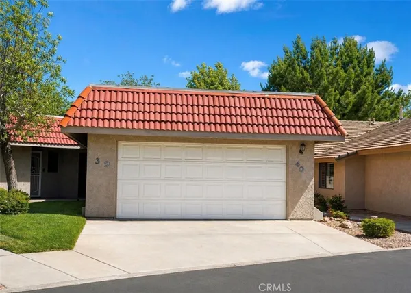a view of a brick house with a garage
