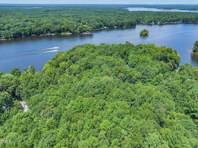 an aerial view of a houses with outdoor space and lake view