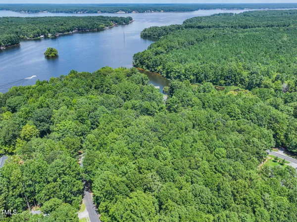 an aerial view of a houses with outdoor space and lake view