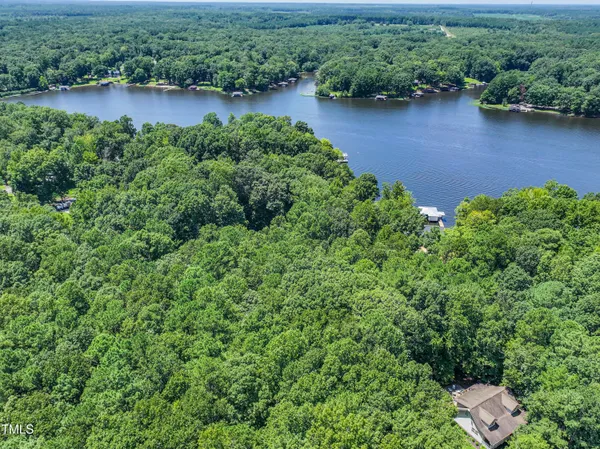 an aerial view of a house with outdoor space and lake view