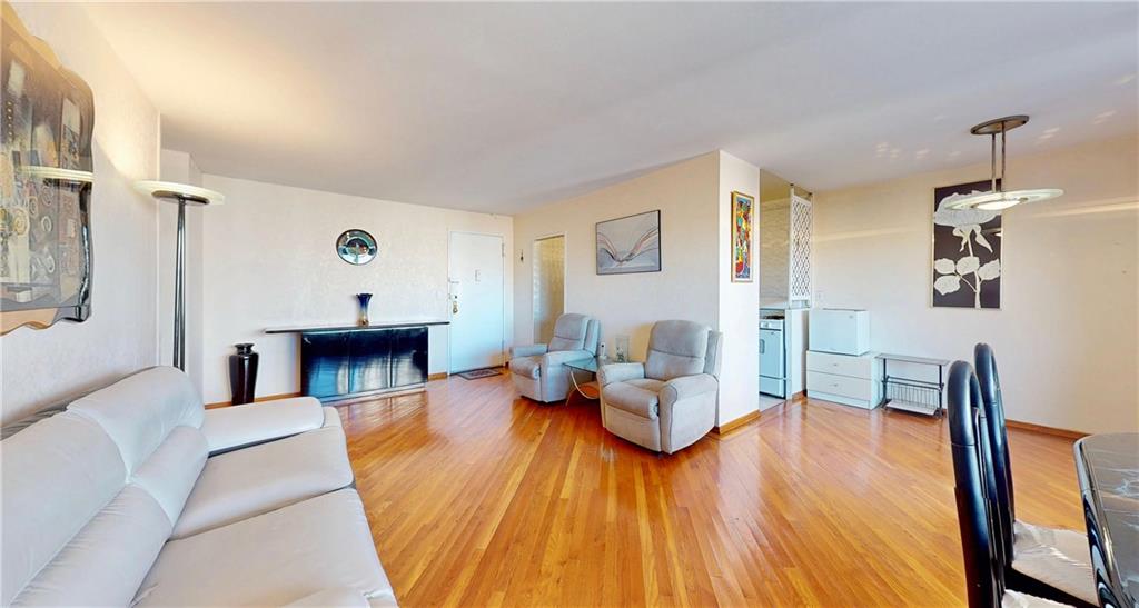 2932 West 5th Street, Unit 15H Brooklyn, NY 11224 - Photo 7 of 15 a living room with furniture and a wooden floor