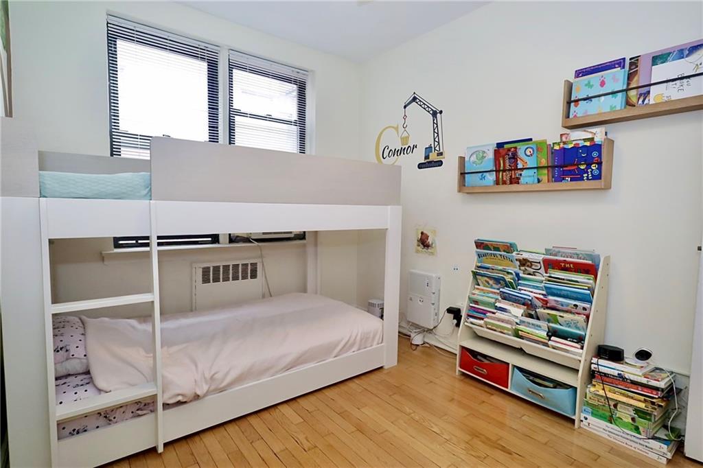 302 96th Street, Unit 3P Brooklyn, NY 11209 - Photo 11 of 19 a bedroom with furniture and a book shelf