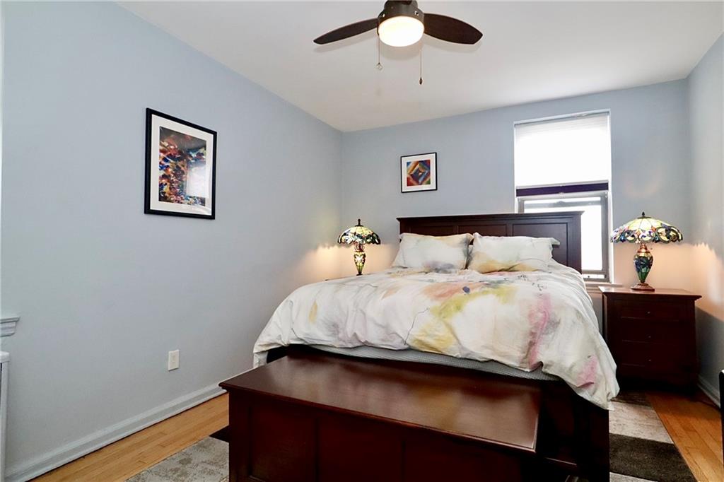 302 96th Street, Unit 3P Brooklyn, NY 11209 - Photo 13 of 19 a bedroom with a bed and wooden floor