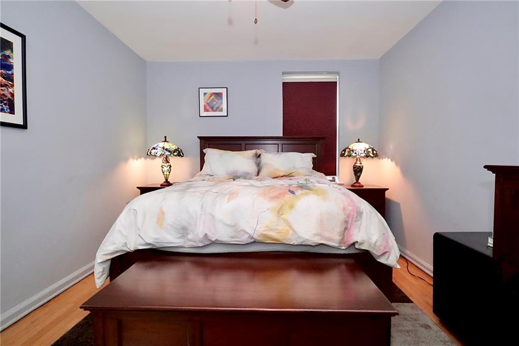 302 96th Street, Unit 3P Brooklyn, NY 11209 - Photo 14 of 19 a bed sitting in a bedroom next to a lamp