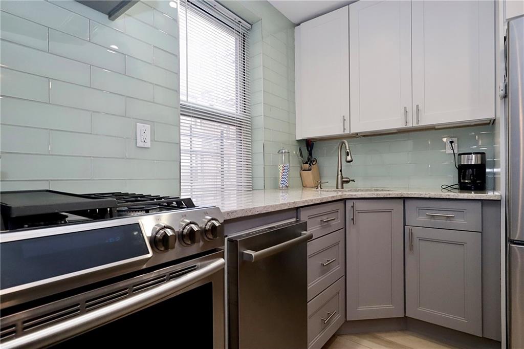 302 96th Street, Unit 3P Brooklyn, NY 11209 - Photo 5 of 19 a kitchen with cabinets appliances a sink and a window