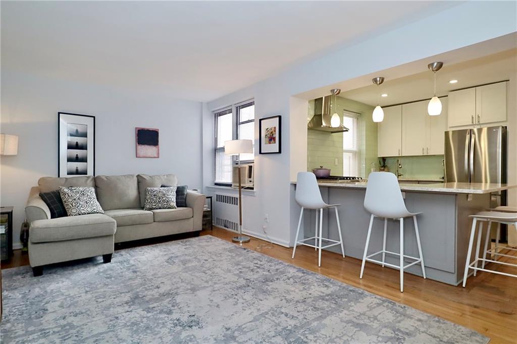 302 96th Street, Unit 3P Brooklyn, NY 11209 - Photo 9 of 19 a living room with furniture a large window and a wooden floor