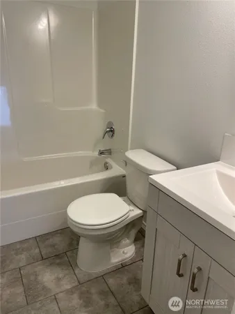 a white toilet sitting next to a bath tub