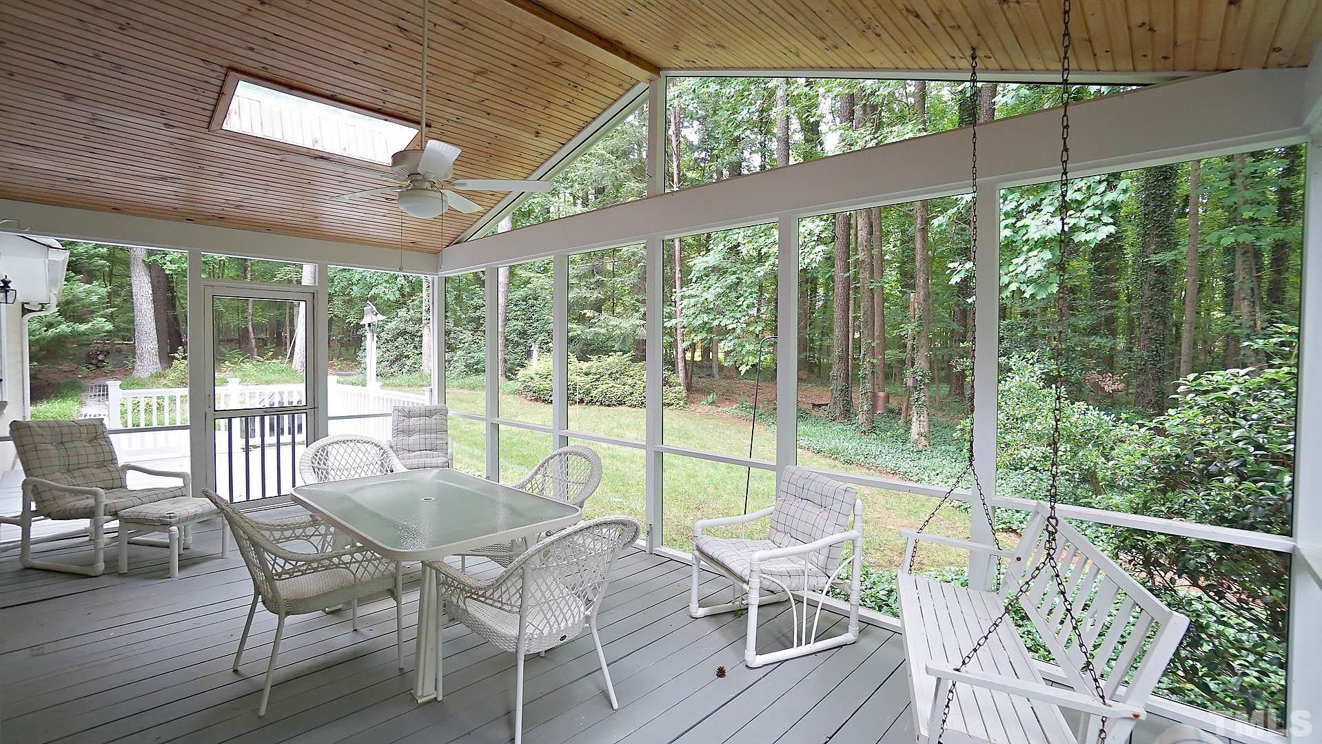 5706 Russell Road Durham, NC 27712 - Photo 3 of 20 a view of a patio with lawn chairs and wooden floor