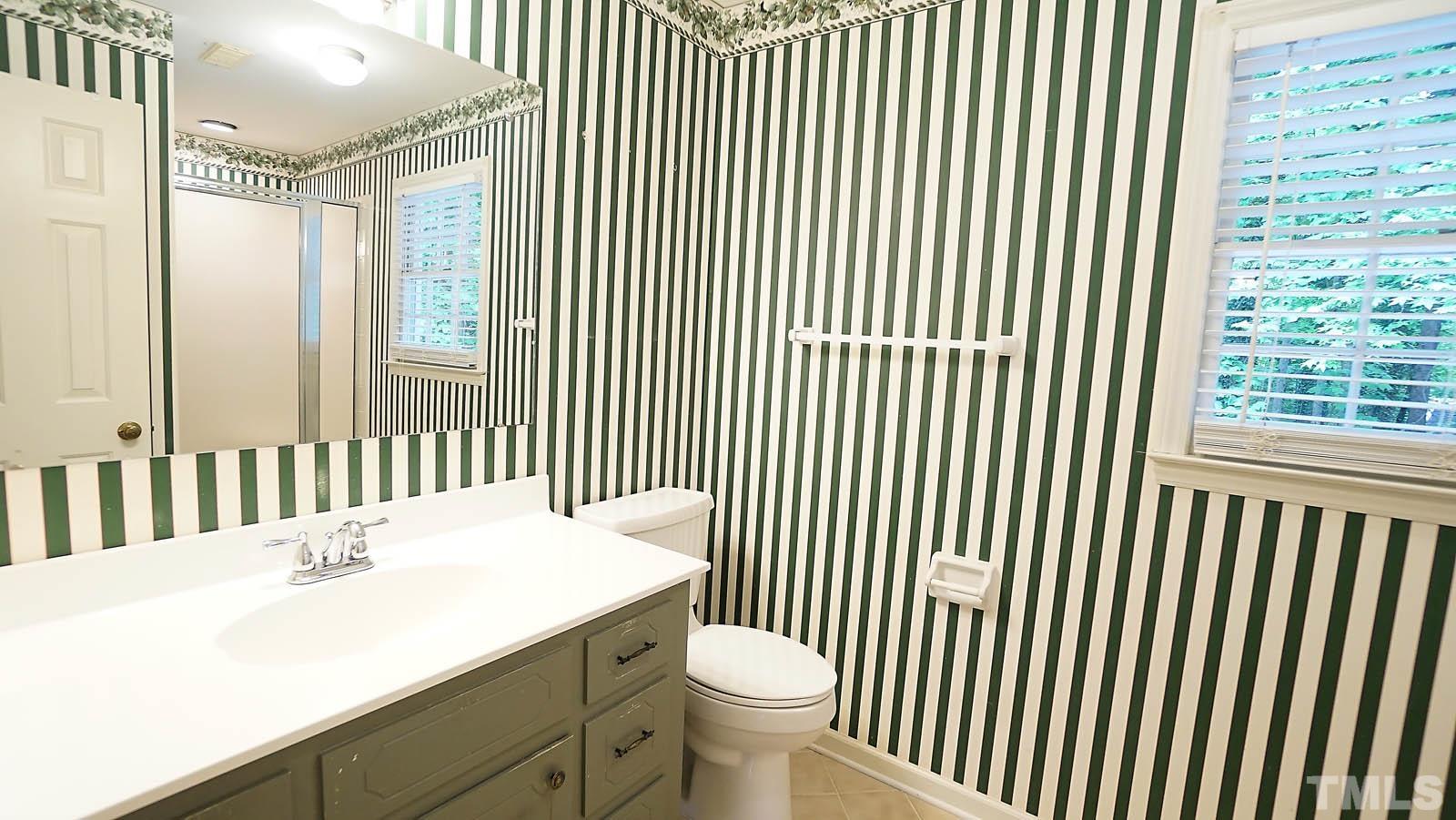 5706 Russell Road Durham, NC 27712 - Photo 9 of 20 a bathroom with a sink a toilet and a large window