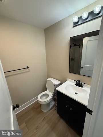 a bathroom with a sink mirror vanity and toilet
