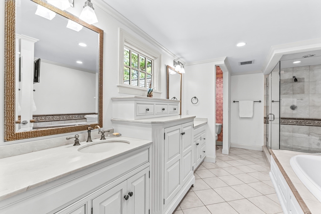 22 Chadwick Road Weston, MA 02493 - Photo 18 of 33 a spacious bathroom with double vanity a mirror a bathtub and a shower