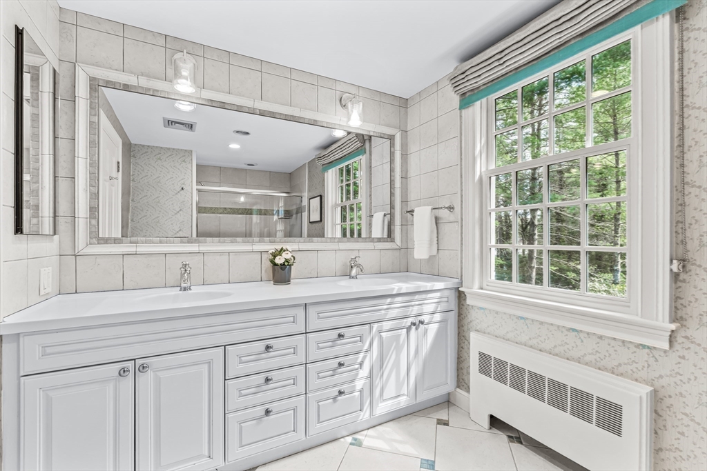 22 Chadwick Road Weston, MA 02493 - Photo 23 of 33 a bathroom with a granite countertop sink mirror and next to a window