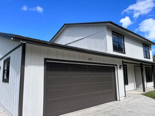a backyard of a house with table and chairs