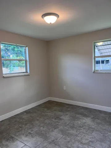 a bathroom with a granite countertop sink and a shower