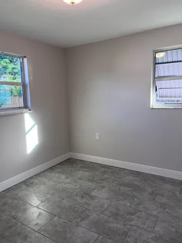 a bathroom with a granite countertop toilet a sink and shower