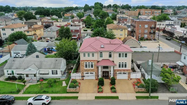 an aerial view of multiple houses with a yard