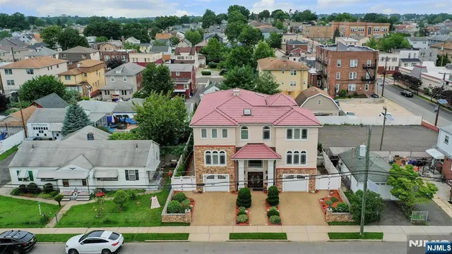 an aerial view of multiple houses with a yard