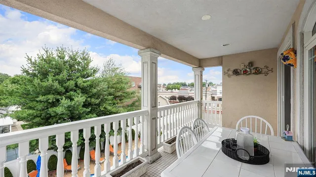 a view of a balcony with chair and wooden floor