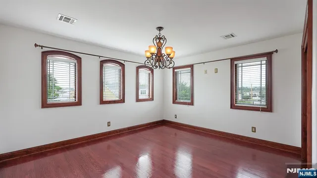 a view of livingroom with chandelier and wooden floor