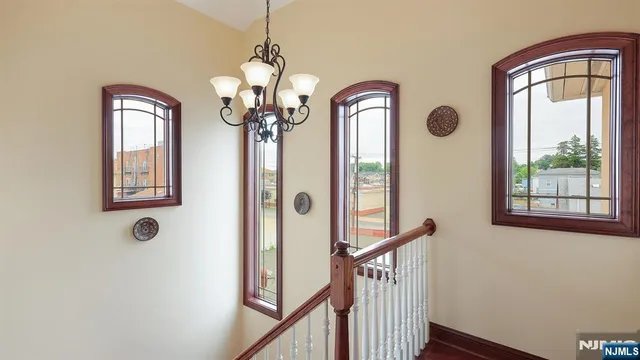 a view of a hallway with windows chandelier