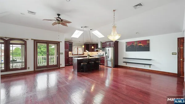 a view of a room with kitchen island and wooden floor