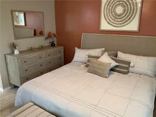 a bedroom with a bed and a dresser