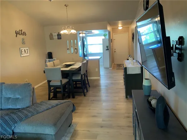 a lobby with furniture and a flat screen tv