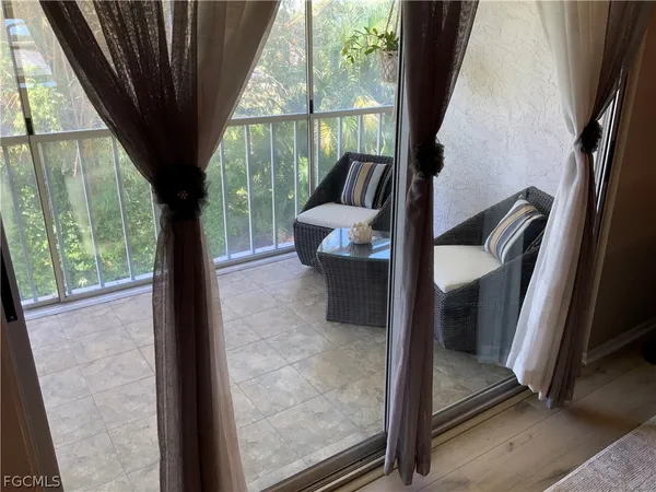 a view of a balcony with furniture