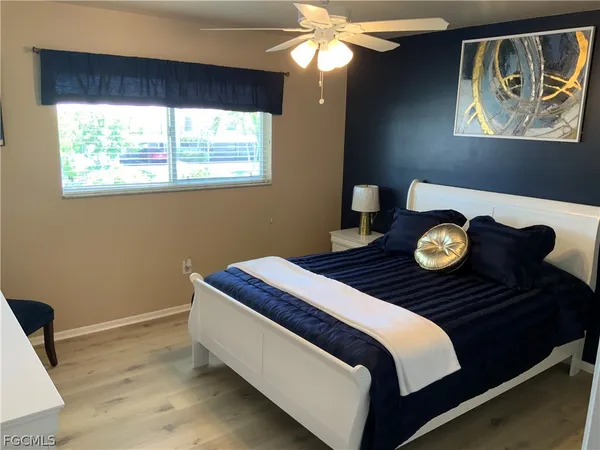 a bed sitting in a bedroom next to a window