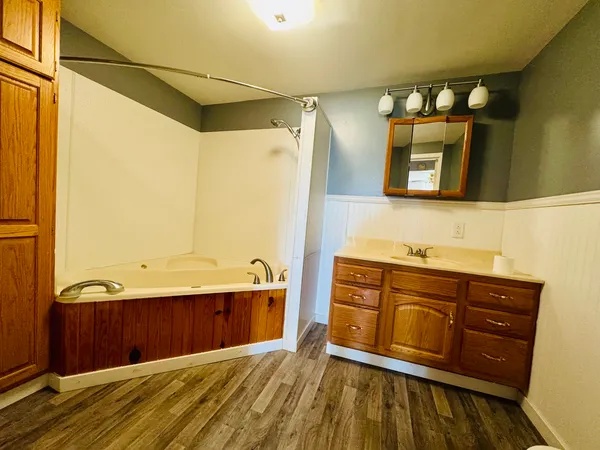 a bathroom with a sink vanity and mirror