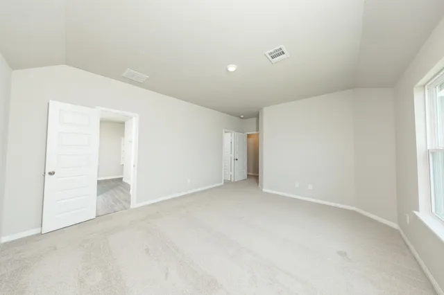 a bathroom with a granite countertop sink a toilet a large mirror and shower