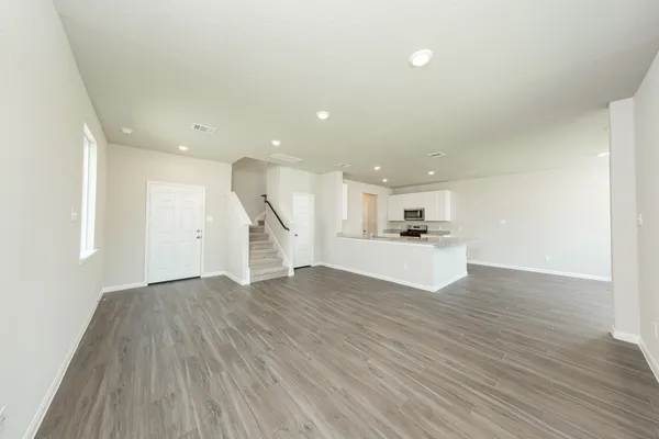 a view of a kitchen with wooden floor and a sink