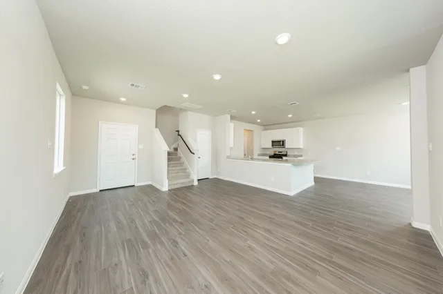 a view of a kitchen with wooden floor and a sink