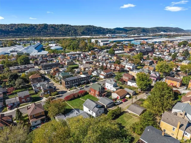 an aerial view of a house with a lake view