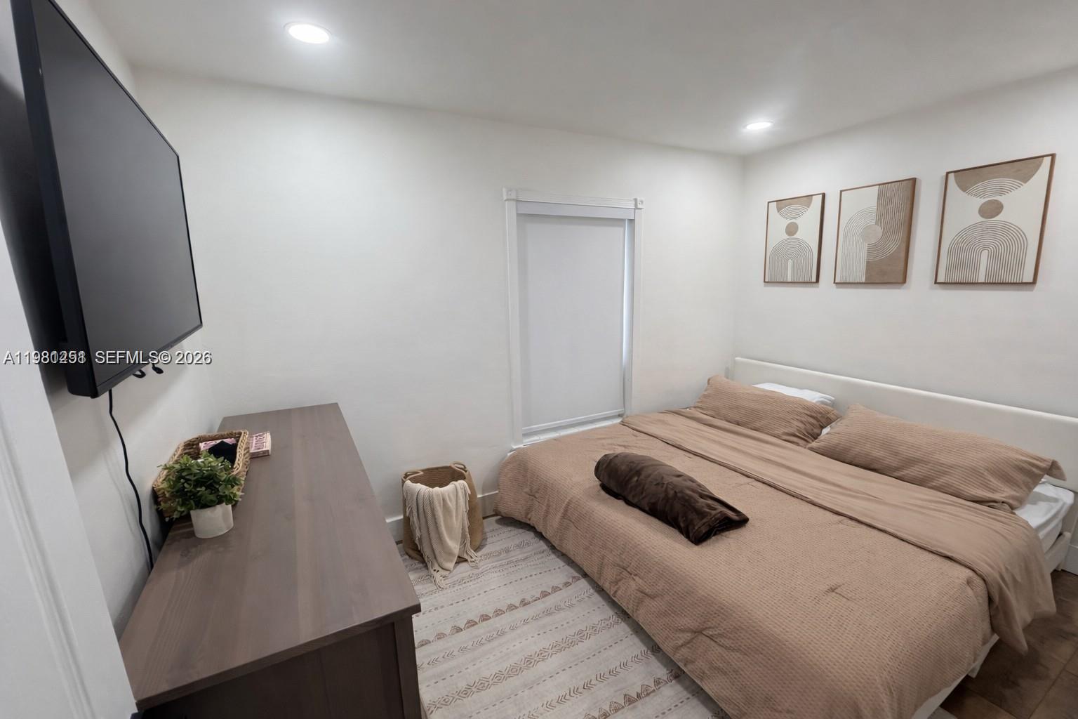 12504 Southwest 112th Terrace Miami, FL 33186 - Photo 5 of 12 a bedroom with a bed and a flat screen tv
