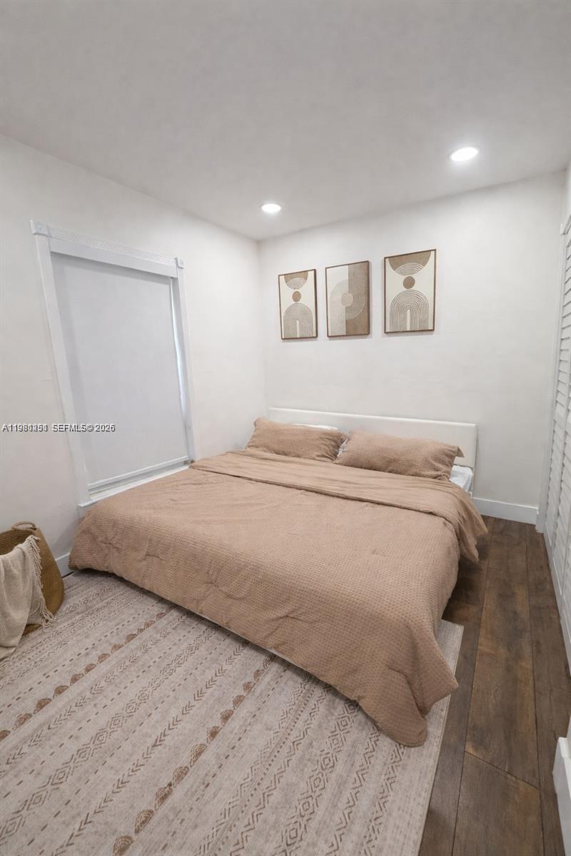 12504 Southwest 112th Terrace Miami, FL 33186 - Photo 6 of 12 a bedroom with a bed and a painting on the wall