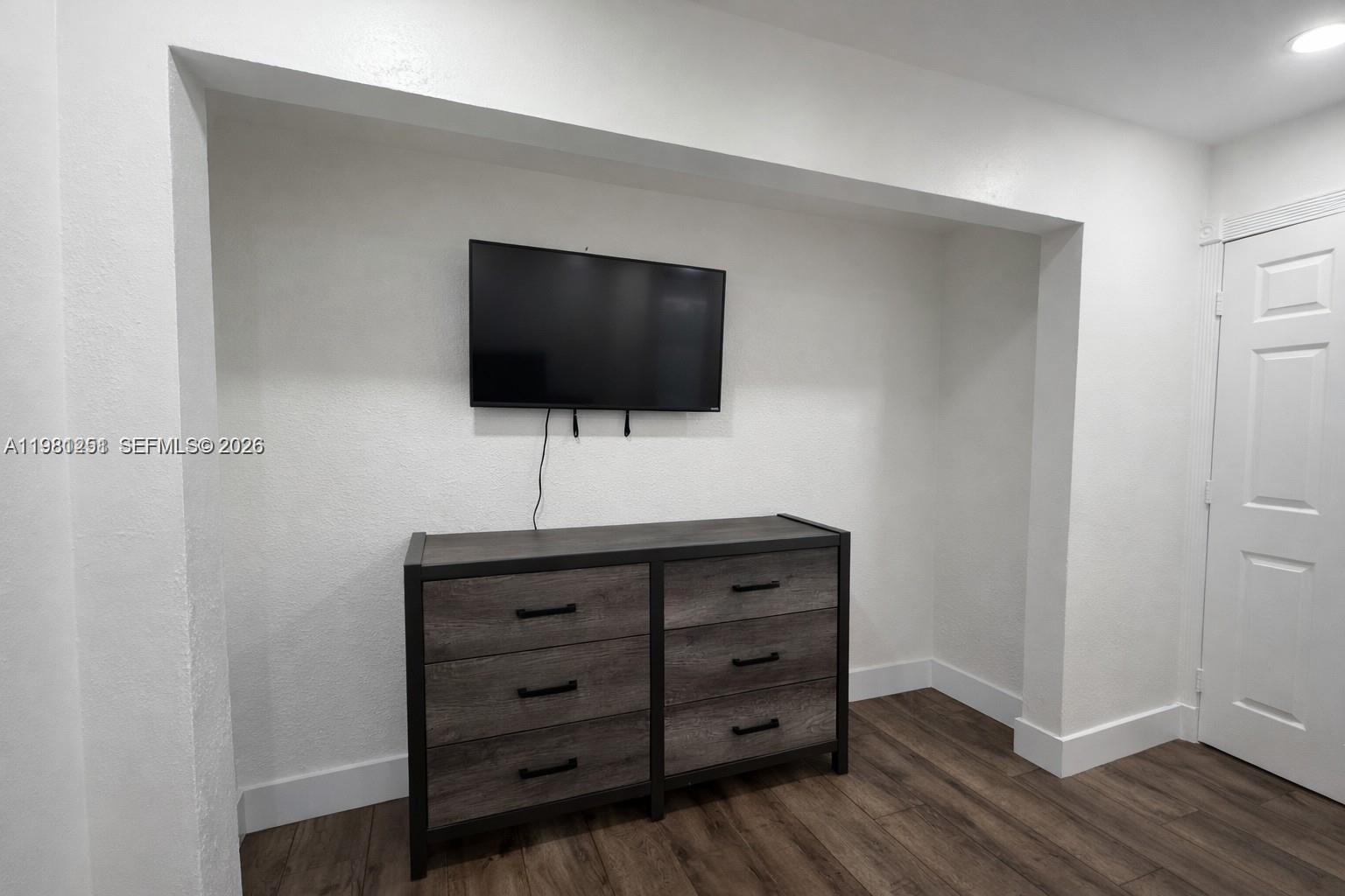 12504 Southwest 112th Terrace Miami, FL 33186 - Photo 8 of 12 a living room with furniture and flat screen tv