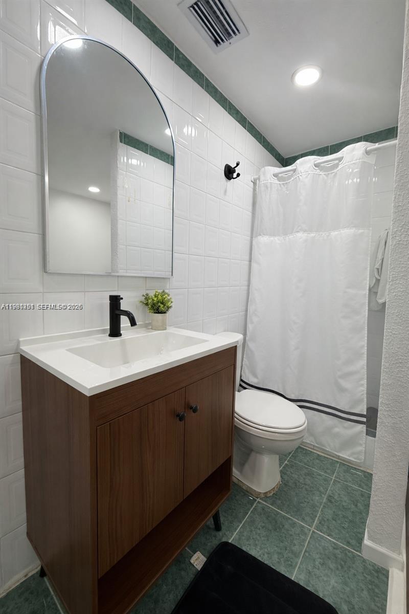 12504 Southwest 112th Terrace Miami, FL 33186 - Photo 9 of 12 a bathroom with a sink and a mirror