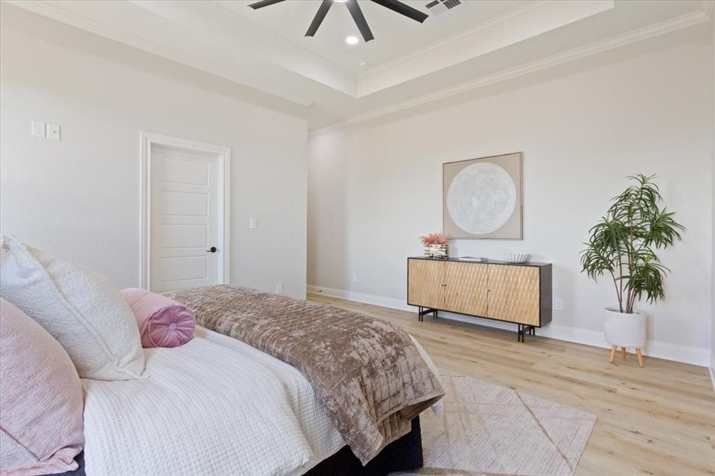 107 North Jena Street Riesel, TX 76682 - Photo 17 of 34 a bedroom with a bed and a potted plant