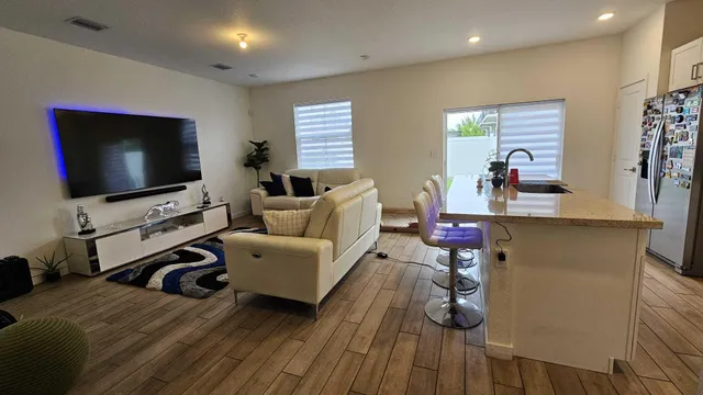 a very nice looking living room with a flat screen tv and furniture