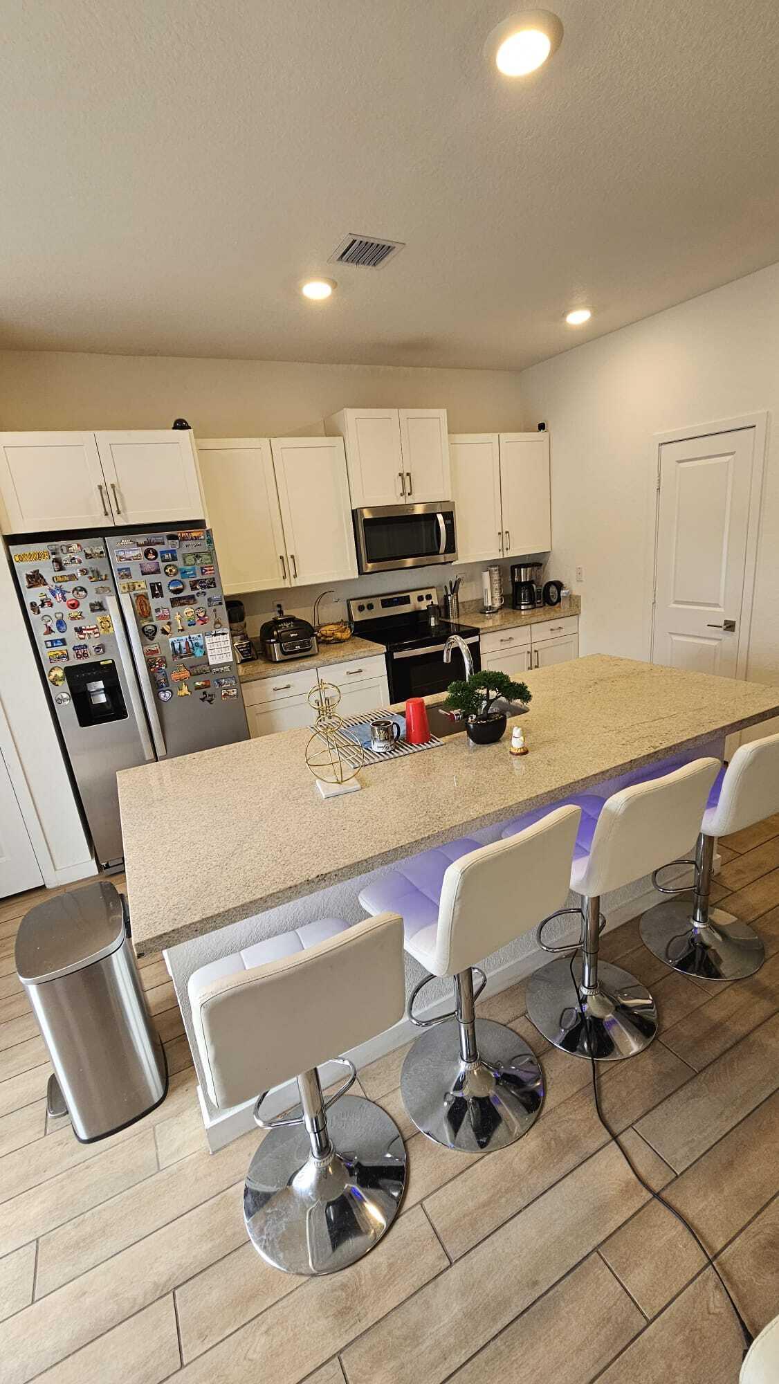 1677 Southeast 8th Street Homestead, FL 33034 - Photo 14 of 52 a kitchen with a sink a stove and white cabinets