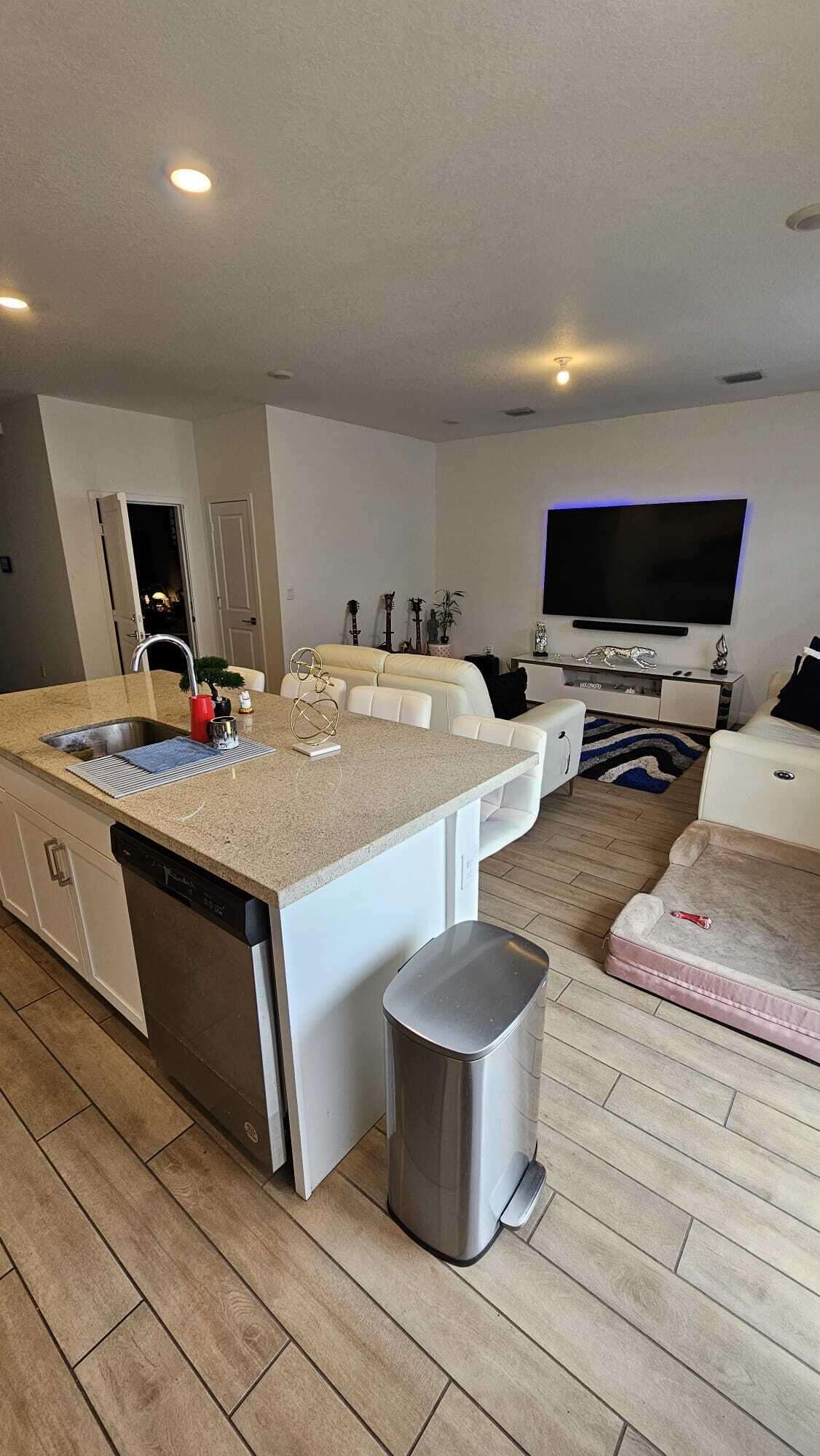 1677 Southeast 8th Street Homestead, FL 33034 - Photo 17 of 52 a room with furniture a flat screen tv and kitchen view